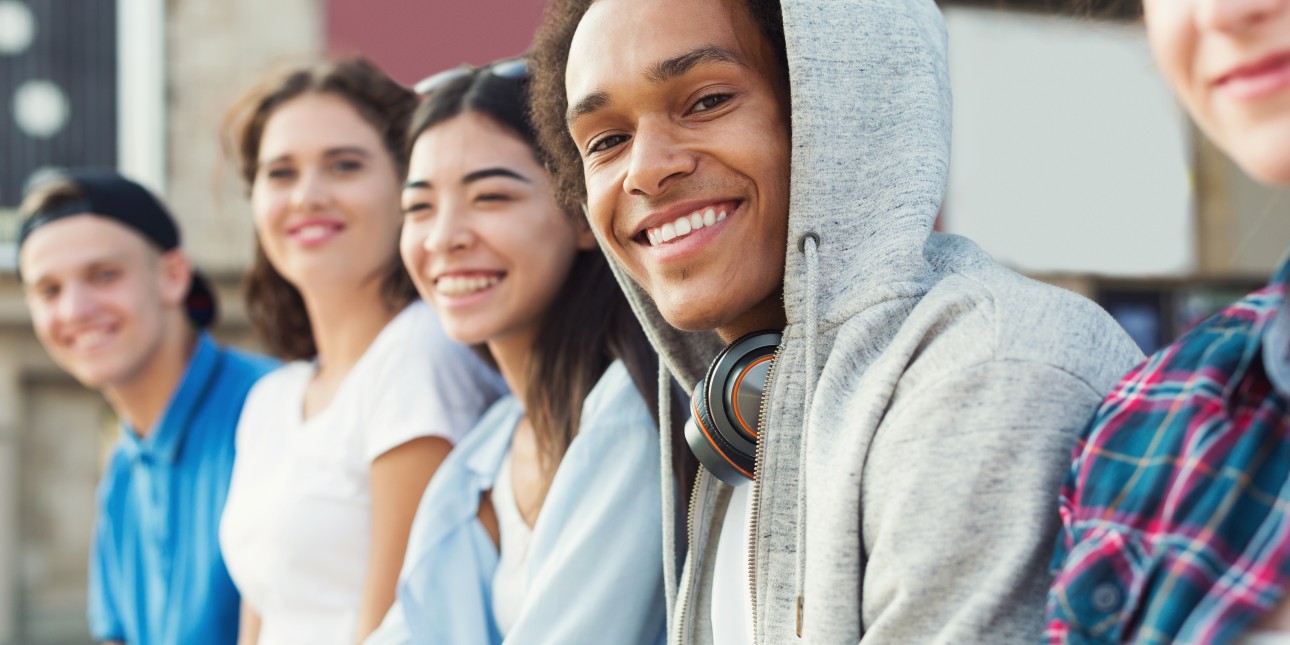 teens sitting outside of high school